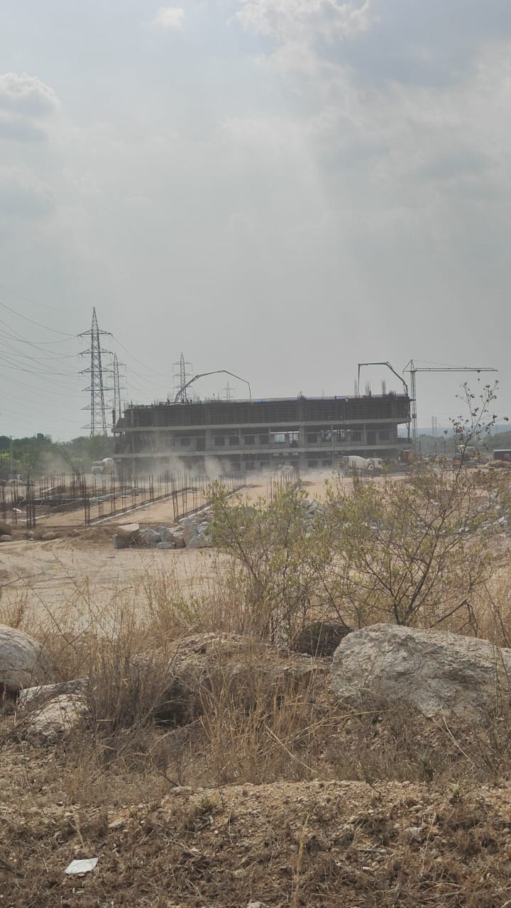 Construction site with concrete boom pumps and mixer truck